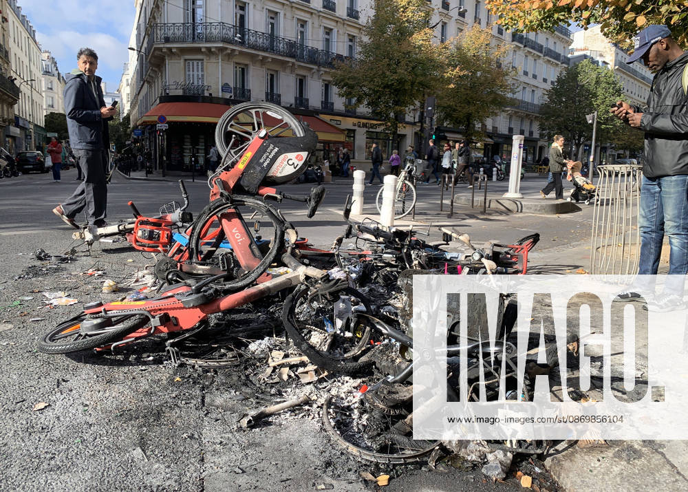 Men look at a pile of burnt-out bicycles near Republique Square in Paris, on Sunday, October 18, 2026. Residents awoke to scenes of widespread damage with shopfronts shattered, burnt out cars, charred bikes, and piles of glass and debris on the pavements of the French capital a day after riots erupted during protests against rising fuel prices, the cost of living and deteriorating public services, including schools. PAR20261018116 MAYAxVIDON-WHITE
