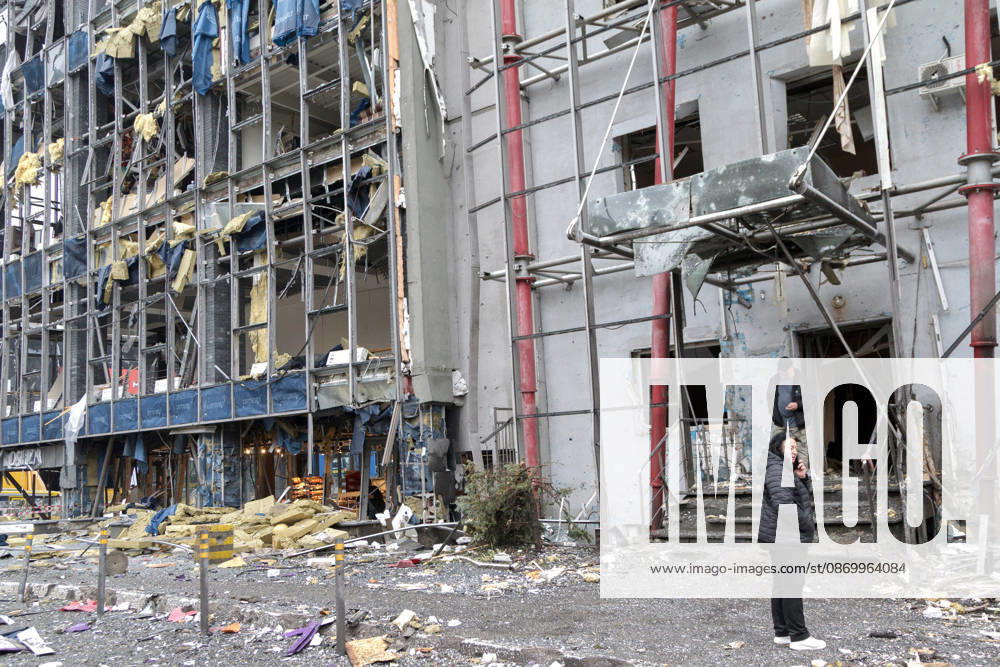 People stand outside a building in the Solomianskyi district damaged by a Russian attack, Kyiv, Ukraine, October 19, 2026. During the night and morning, Russia launched a massive strike on the capital using ballistic missiles, cruise missiles, and drones. According to Kyiv city head Vitali Klitschko, five people were injured in the Solomianskyi district as a result of the attack. Four residential buildings, a bank office, a private medical clinic, a shopping mall, offices, and vehicles were damaged. (Photo by Kyrylo Chubotin Ukrinform) Russian attack on Kyiv affects shopping mall