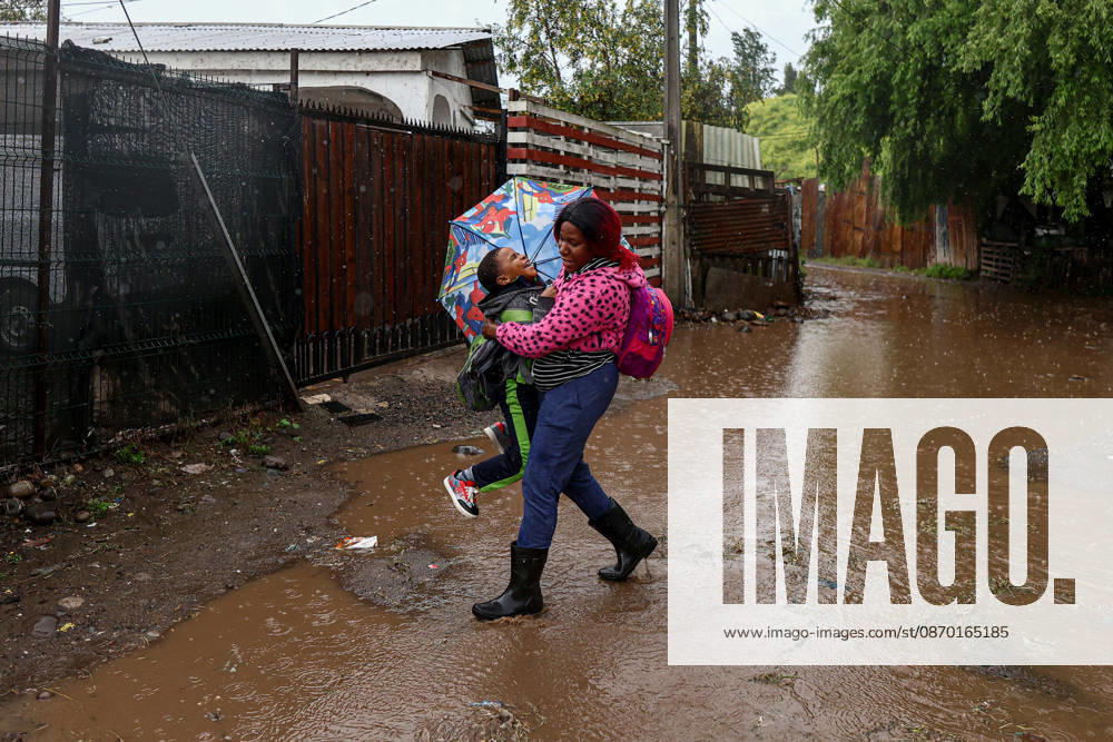 Heavy rainfall triggers red alert and emergency evacuations in Chile TALAGANTE, CHILE – OCTOBER 20: A migrant woman helps her son cross a flooded street in Talagante, on the outskirts of Santiago, Chile, on October 20, 2026. On Tuesday, Chile declared a red alert for the Metropolitan Region due to heavy rainfall, marking the wettest October in Santiago in more than a century. Lucas Aguayo Araos Anadolu Talagante Chile. Editorial use only. Please get in touch for any other usage.
