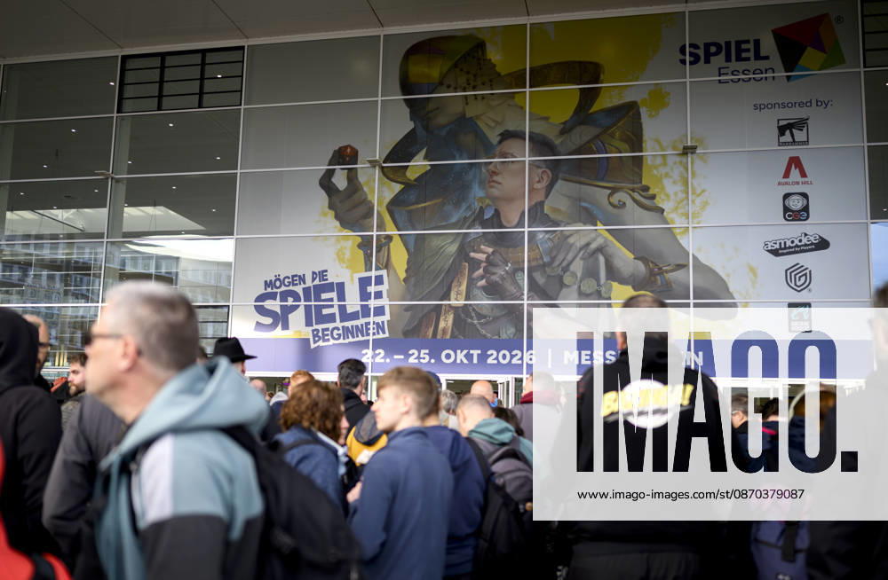 Visitors wait in front of the East Entrance; a rush of people; behind them, the SPIEL 26 logo; on October 22, 2026, at the SPIEL Essen trade show, held from October 22–25, 2026, in Essen, Germany, at the Grugahalle