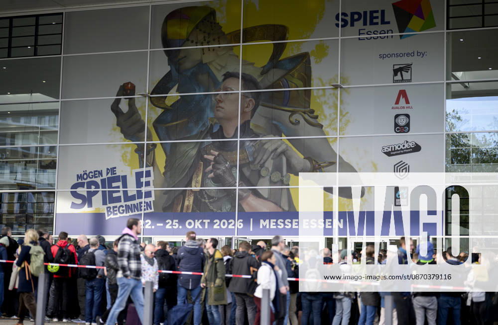 Visitors wait in front of the East Entrance; a rush of people; behind them, the SPIEL 26 logo; on October 22, 2026, at the SPIEL Essen trade show, held from October 22–25, 2026, in Essen, Germany, at the Grugahalle