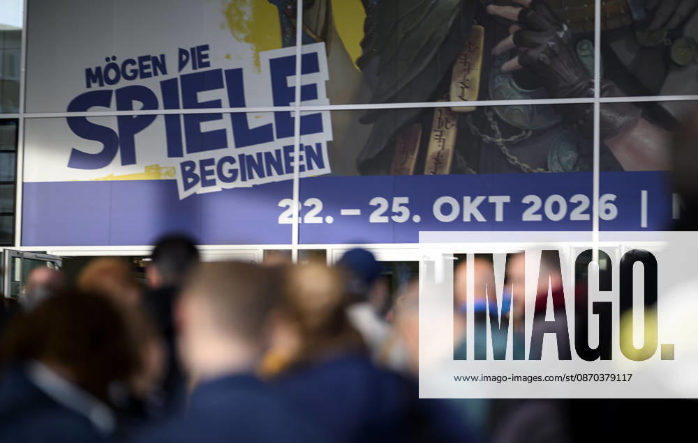 Visitors wait in front of the East Entrance; a rush of people; behind them, the SPIEL 26 logo; on October 22, 2026, at the SPIEL Essen trade show, held from October 22–25, 2026, in Essen, Germany, at the Grugahalle