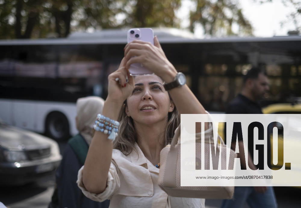 Anti-U.S. President Trump Performance On Billboard Reactions An Iranian woman films a masked man (not pictured) performing as U.S. President Donald Trump inside a symbolic cell mounted on a billboard in northern Tehran, Iran, on October 22, 2026, amid escalating tensions between Iran and the United States. Tehran Tehran Iran