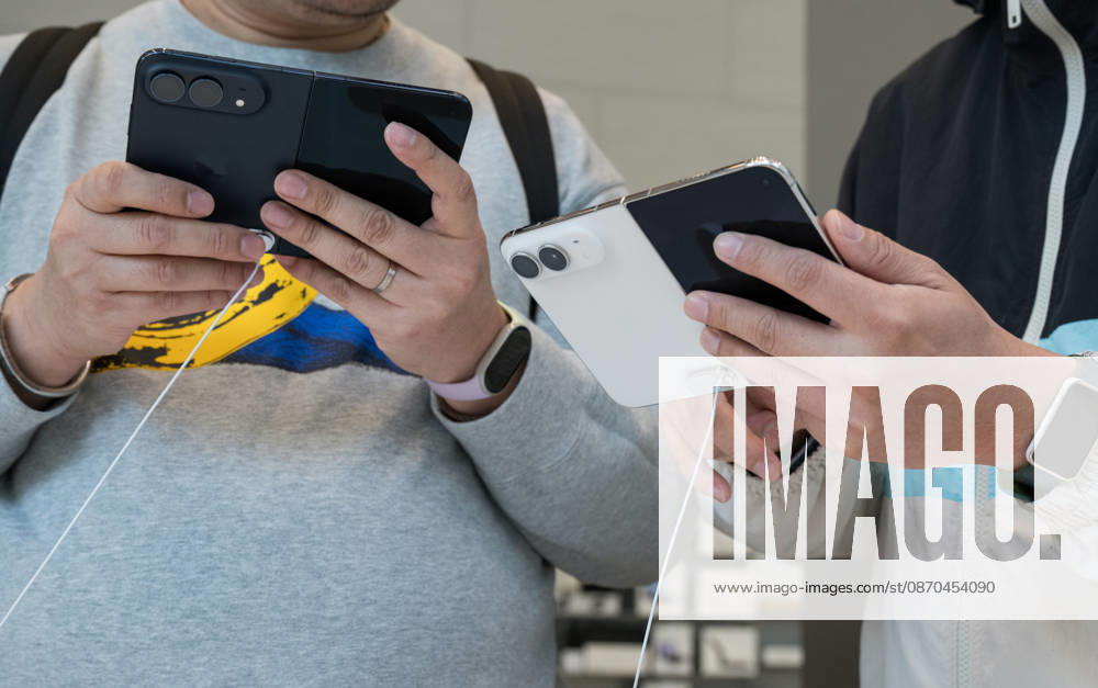 Consumers experience the new iPhone Duo foldable smartphone inside an Apple Store at China World Mall on October 23, 2026 in Beijing, China. Apple has launched its first foldable phone model for sale starting today.