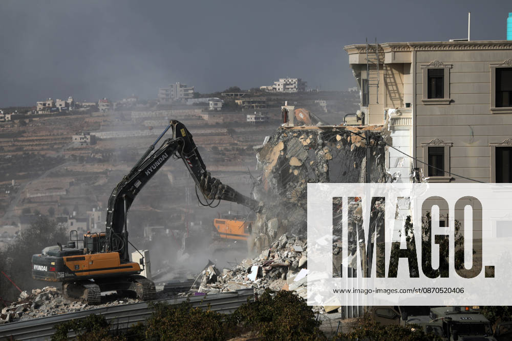 Israeli forces demolish a building in West Bank city of Hebron HEBRON, WEST BANK, PALESTINE - OCTOBER 23: Israeli military heavy machinery demolishes a building during a raid in the West Bank city of Hebron, Palestine, on October 23, 2026. The Israeli military announced earlier in the morning that two of its soldiers were killed during armed clashes with Palestinians, triggering a large-scale military operation and structural demolition in the city. Mamoun Wazwaz Anadolu Hebron West Bank. Editorial use only. Please get in touch for any other usage.