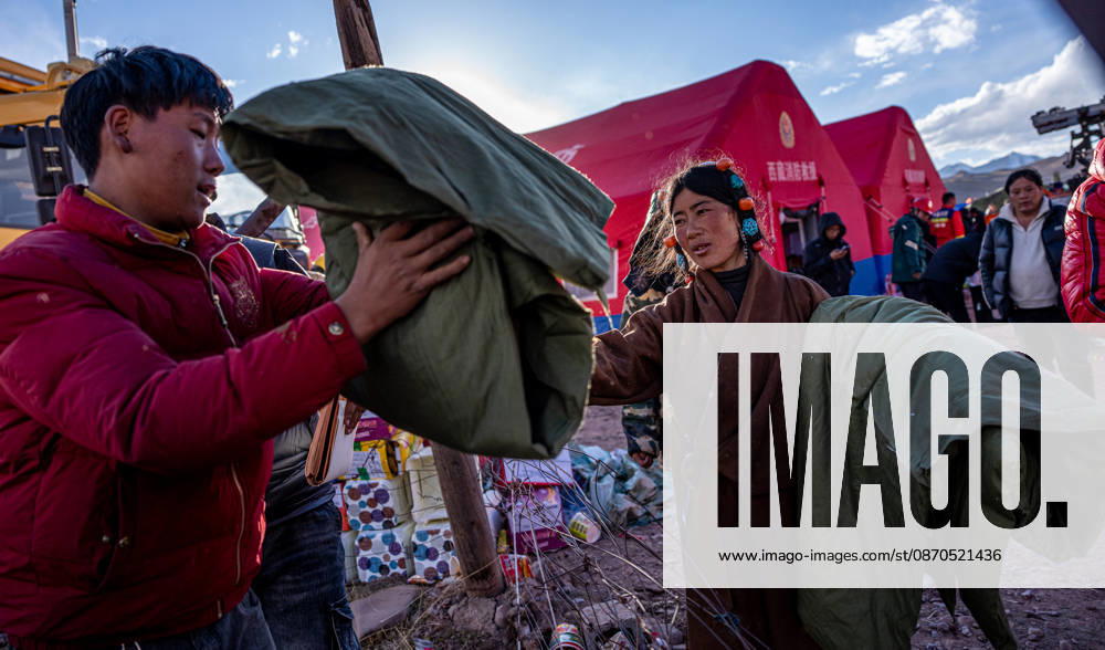 (261023) -- NAGQU, Oct. 23, 2026 -- Villagers receive quilts at a temporary resettlement site of an earthquake-hit village in Maru Township of Baqen County, Nagqu City, southwest China s Xizang Autonomous Region, Oct. 23, 2026. China has allocated 50 million yuan (about 7.5 million U.S. dollars) in emergency disaster relief funds and earmarked another 30 million yuan for recovery efforts following a 7.0-magnitude earthquake in southwest China s Xizang Autonomous Region. The earthquake struck Baqen County of the city of Nagqu at 10:33 p.m. on Thursday, leaving 16 people dead and 54 injured. ) (SpotNews) CHINA-XIZANG-NAGQU-EARTHQUAKE-RESETTLEMENT (CN) TenzinxNyida