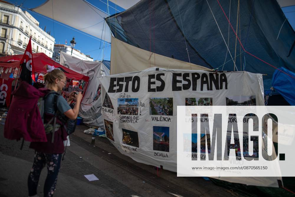 A banner featuring photographs and the phrase This is Spain can be seen at Puerta del Sol..Tents remain set up by housing rights activists, who organized the occupation of the square in response to the eviction of MaricarmenÃ¢â‚¬a woman in her eightiesÃ¢â‚¬from her home, carried out by a real estate investment fund. Madrid Spain - ZUMAs197 20261023_aaa_s197_153