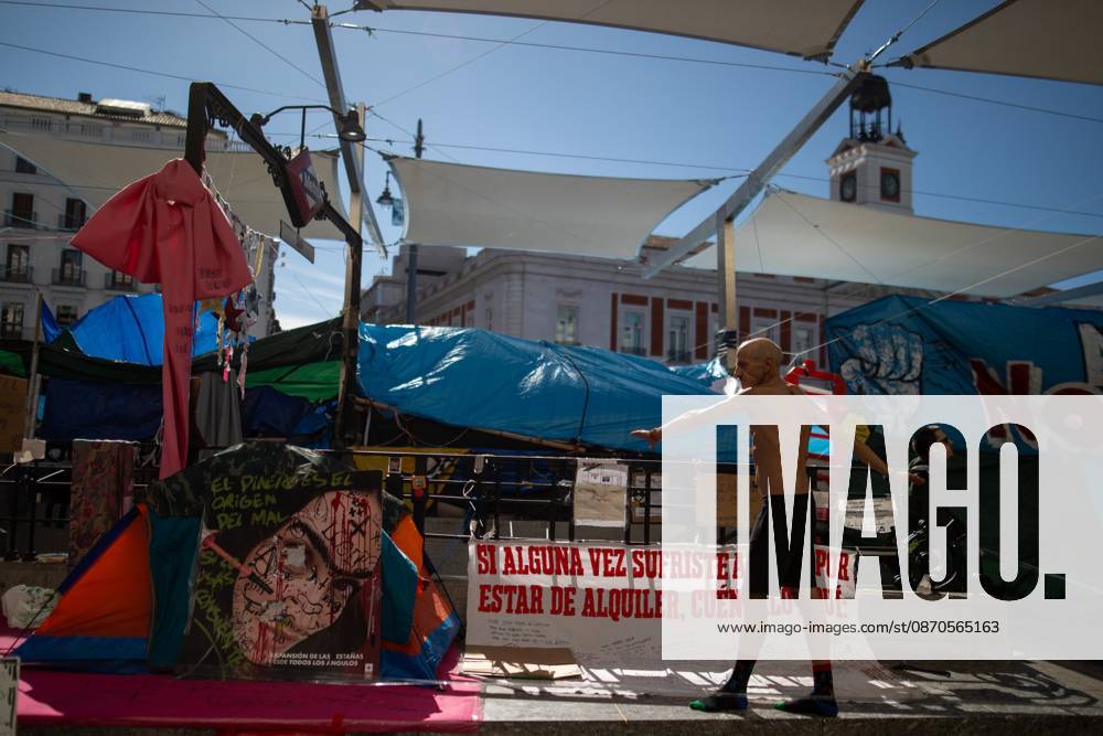 A man performs a piece in front of tents set up at Puerta del Sol..Tents remain set up by housing rights activists, who organized the occupation of the square in response to the eviction of MaricarmenÃ¢â‚¬a woman in her eightiesÃ¢â‚¬from her home, carried out by a real estate investment fund. Madrid Spain - ZUMAs197 20261023_aaa_s197_150