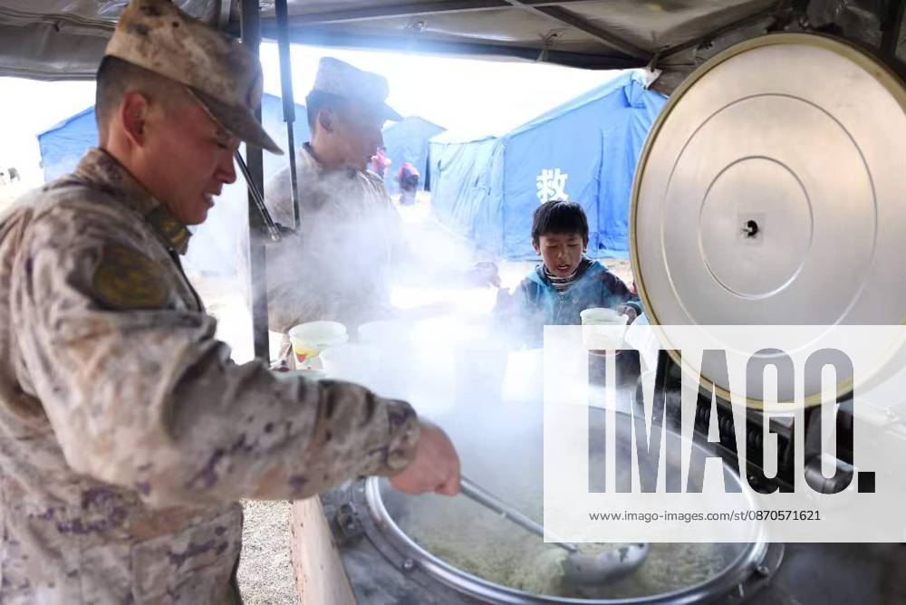 (261024) -- NAGQU, Oct. 24, 2026 -- A soldier from a local subcommand of the Western Theater Command of the Chinese People s Liberation Army cooks meal for local residents at a temporary resettlement site of a quake-hit village in Maru Township of Baqen County, Nagqu City, southwest China s Xizang Autonomous Region, Oct. 23, 2026. Sixteen people have been killed and 76 others are injured following a 7.0-magnitude earthquake that struck Baqen County of the city of Nagqu in southwest China s Xizang Autonomous Region at 10:33 p.m. on Thursday, local authorities said. The Western Theater Command of the Chinese People s Liberation Army has coordinated ground and air forces to assess the damage and carry out search-and-rescue operations. Mor