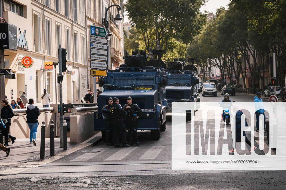 Marseille France Street Protests Police officers stand beside military vehicles on a street in Marseille, France on October 24, 2026. Authorities deployed around 70,000 security personnel across France for renewed protests over the cost of living, after unrest a week earlier saw public buildings damaged, hundreds of shops looted and about 2,700 people arrested. Marseille Provence-Alpes-CÃ te France