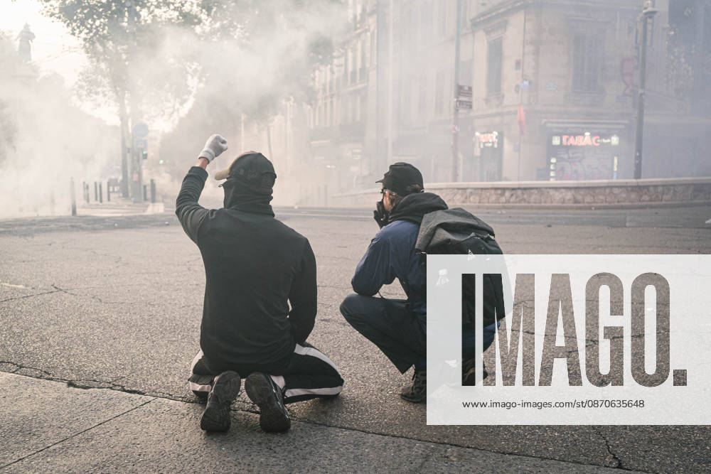 Marseille France Street Protests Demonstrators crouch amid smoke during a protest in Marseille, France on October 24, 2026. Authorities deployed around 70,000 security personnel across France for renewed protests over the cost of living, after unrest a week earlier saw public buildings damaged, hundreds of shops looted and about 2,700 people arrested. Marseille Provence-Alpes-CÃ te France