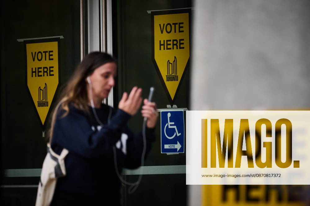 A person passes election signage as they head to the polls to vote in Toronto s municipal election, on Monday, Oct. 26, 2026. Toronto Canada - ZUMAc35_ 20261026_zaf_c35_070