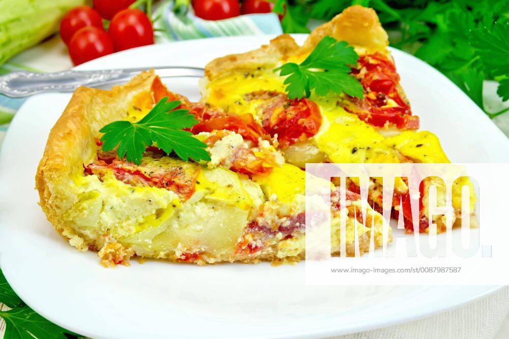 Flan with tomato and zucchini in plate on light board