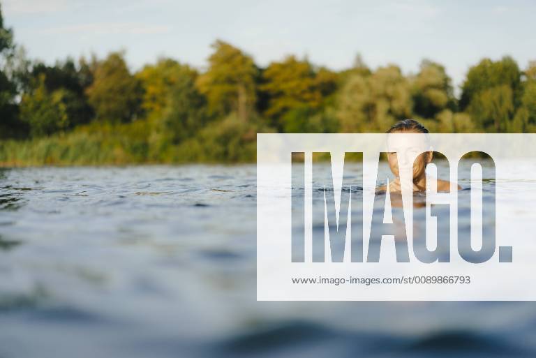 Portrait of smiling woman swimming in a lake model released Symbolfoto property released KNSF05161