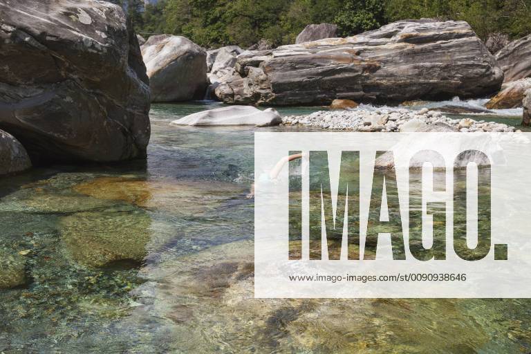 Switzerland, Ticino, Verzasca Valley, woman swimming in refreshing Verszasca river model released Symbolfoto GWF05965