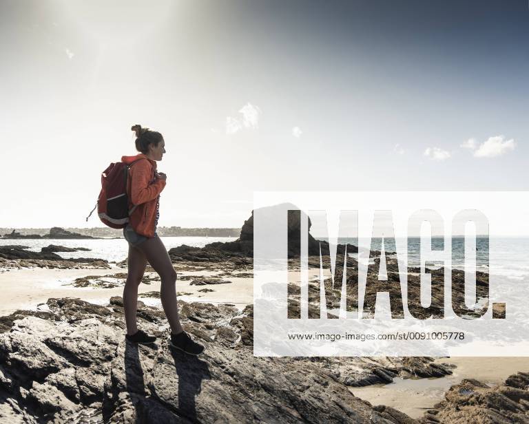 Young woman hiking on a rocky beach model released Symbolfoto UUF16454