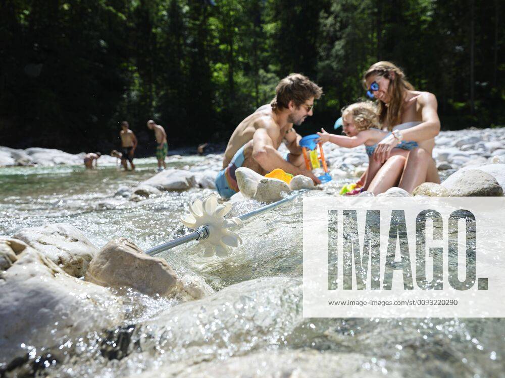 Family with daughter playing in a mountain stream model released Symbolfoto CVF01375