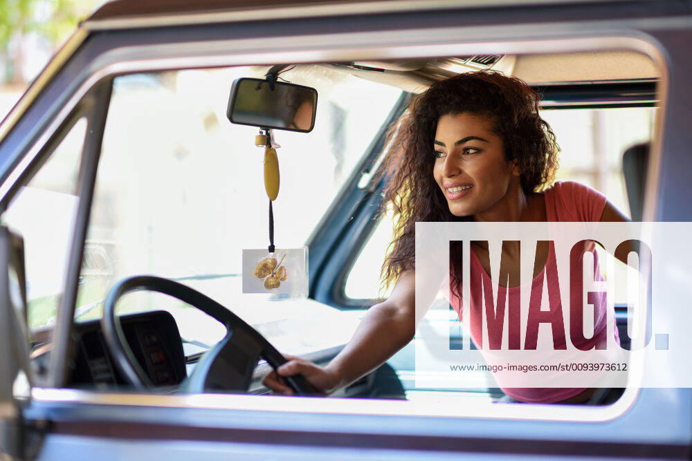 Arab woman inside an old van parked in a campsite in the middle of nature,model released, Symbolfoto INH_18944_06245
