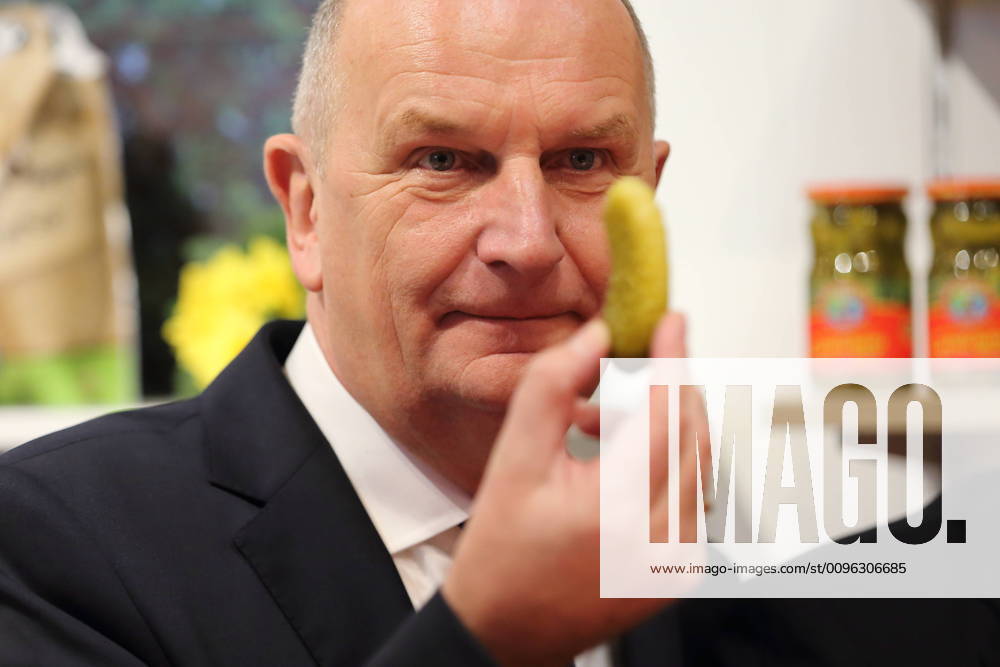 Minister President Dietmar Woidke SPD looks at a Spreewald gherkin before tasting it during a tour of Brandenburg Day at the Green Week in Berlin, 20 January 2020 Green Week Brandenburg Day