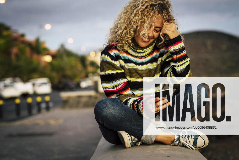 Portrait of woman wearing colorful pullover and using smartphone, Tenerife, Spain model released Symbolfoto SIPF02106