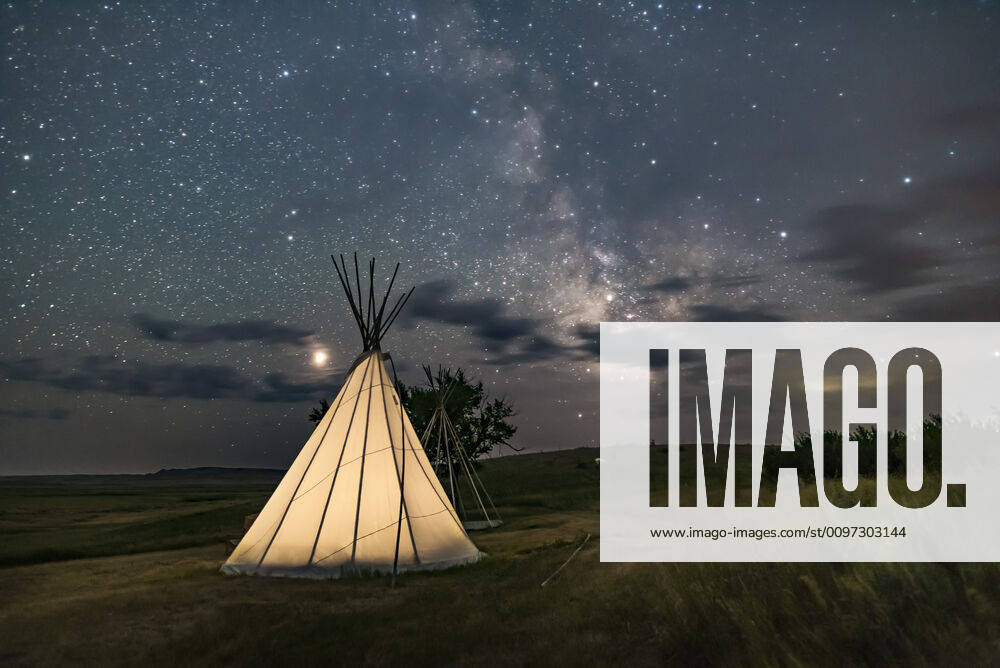 Mars (at left) and the Milky Way (at right) over a single tipi (with another under construction at back) at the Two Trees site at Grasslands National Park, Saskatchewan, August 6, 2018. I placed a low-level warm LED light inside the tipi for the illumination. This is a stack of 6 exposures, mean combined to smooth noise, for the ground, and one untracked exposure for the sky, all 30 seconds at f 2.2 with the 20mm Sigma lens and Nikon D750 at ISO 3200. Alberta Canada