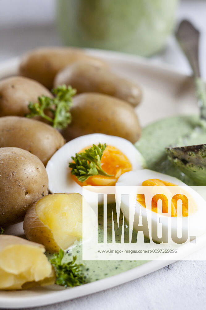Plate of potatoes with boiled eggs, parsley and salsa verde sauce SBDF04187