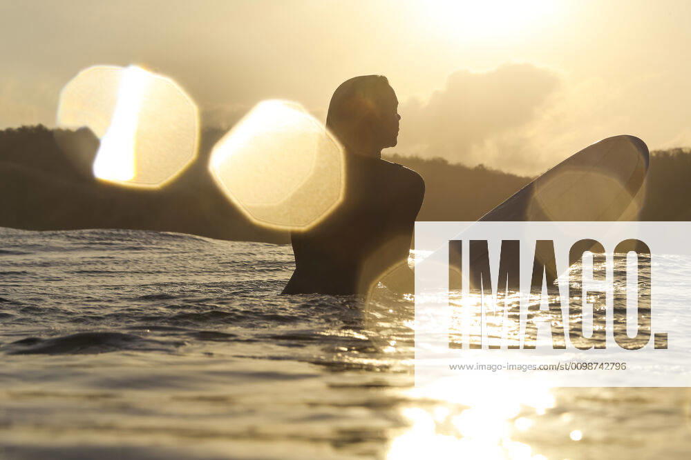 Female surfer in the ocean at sunset Lombok, Nusa Tenggara Bar., Indonesia ,model released, Symbolfoto CR_KOTRIN200312D-290307-01