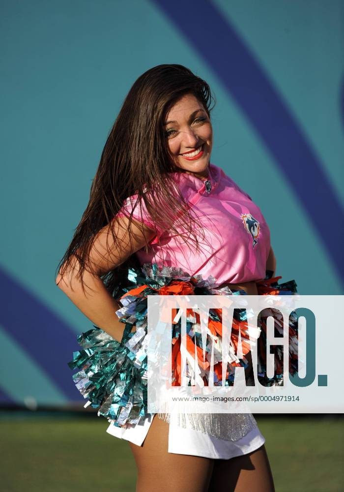 04 October 2009: Miami Dolphin Cheerleader smiles as she dances and  performs with pom poms while