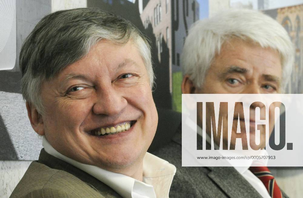 Russian chess grandmasters Boris Spassky, right, and Anatoly Karpov, left,  shake hands the news