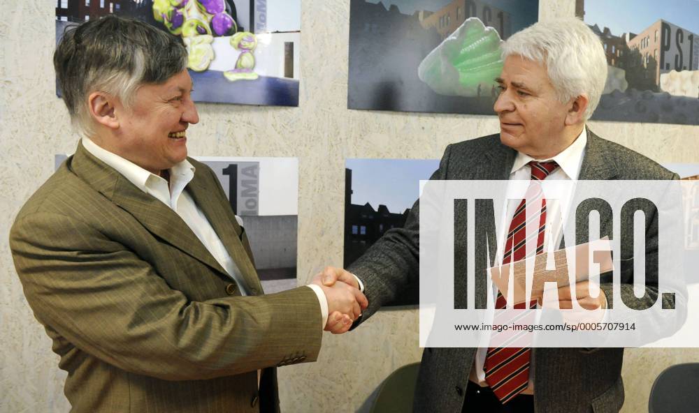 Russian chess grandmasters Boris Spassky, right, and Anatoly Karpov, left,  shake hands the news