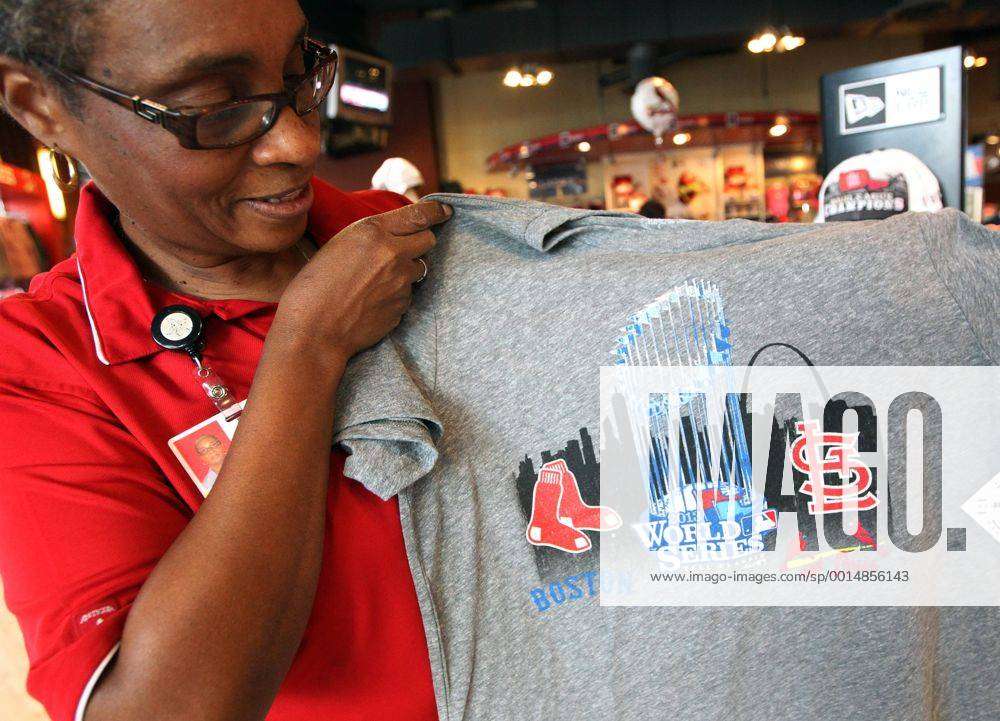 St. Louis Cardinals team store manager Marceline Brooks shows off a new tee  shirt addition to