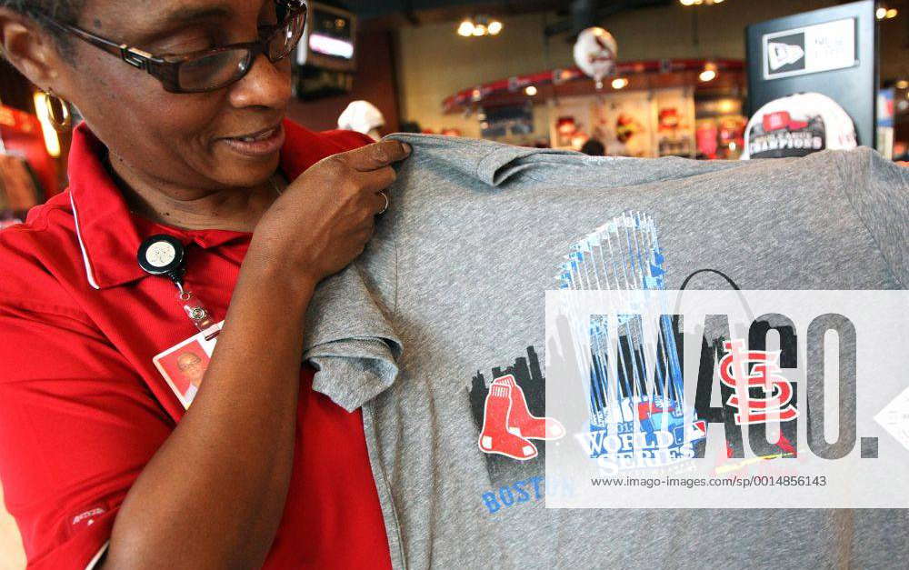 Busch Stadium Team Store manager Marceline Brooks, puts up a new