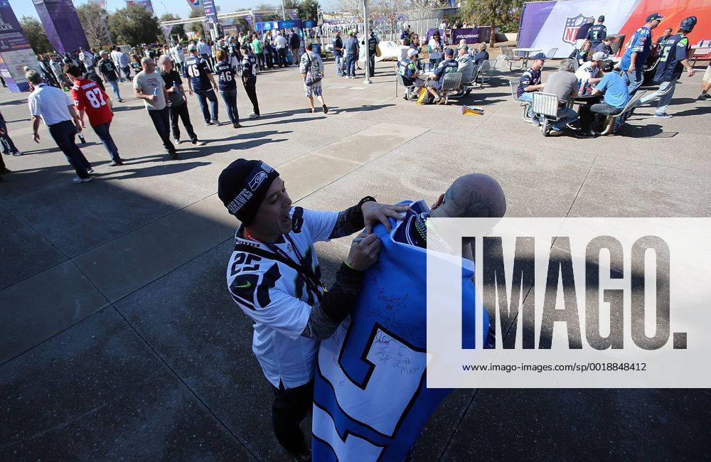 01 February 2015: A Seattle Seahawks fan signs the 12th man flag held ...