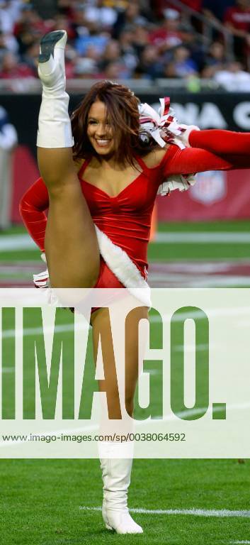 An Arizona Cardinals' cheerleader performs a high kick during the