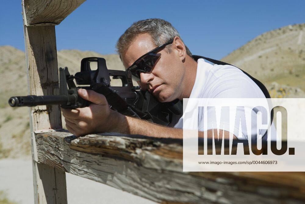 Man aiming machine gun at firing range