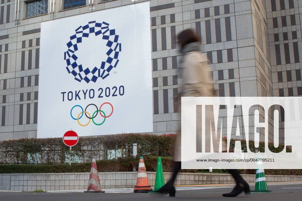 A Woman Walks Past A Large Display Promoting The Tokyo 2020 Olympics In Tokyo Japan On March 