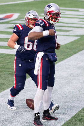 New England Patriots quarterback Cam Newton (1) celebrates with offensive  lineman James Ferentz (66)