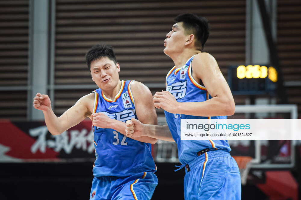 210314) -- ZHUJI, March 14, 2021 -- Wang Qingming (L) of Qingdao Eagles  celebrates with his