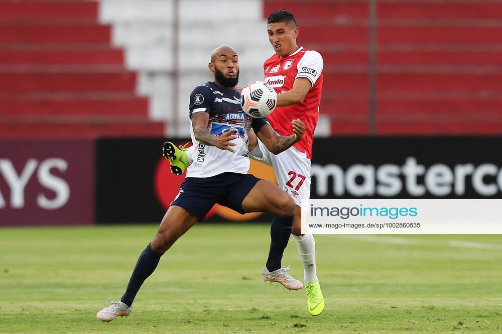 Ciro Alexander Porras R from Santa Fe disputes a ball with Fredy