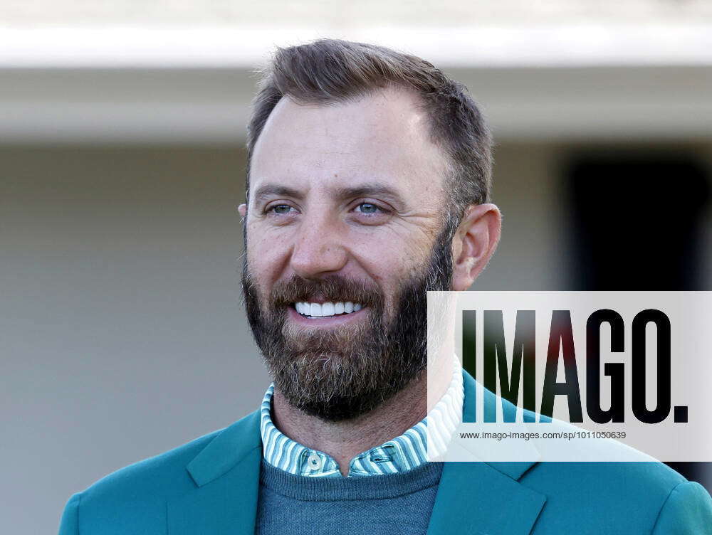 Dustin Johnson wears his green jacket while he waits to hand out awards ...