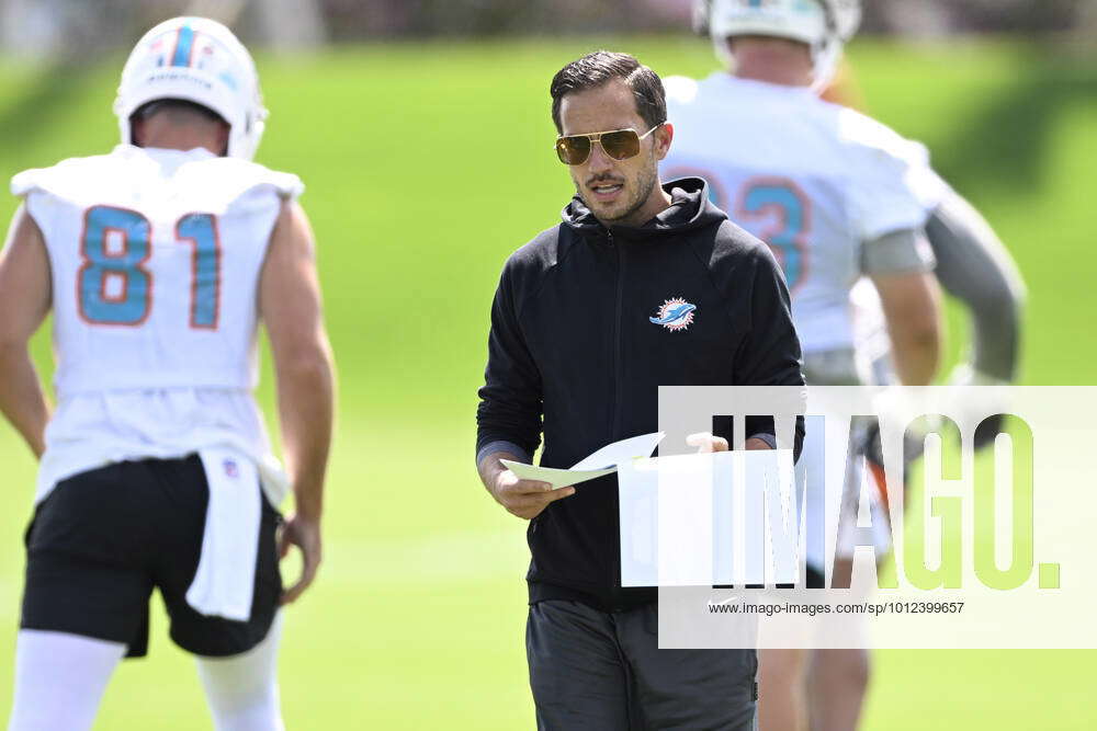 DAVIE, FL - JUNE 01: Miami Dolphins head coach Mike McDaniel (black hoodie)  looks on as the