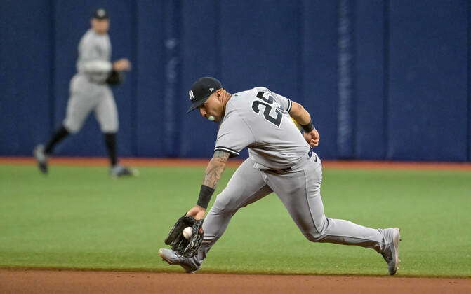 New York Yankees second baseman Gleyber Torres (25) blows a bubble while  fielding a ground ball hit