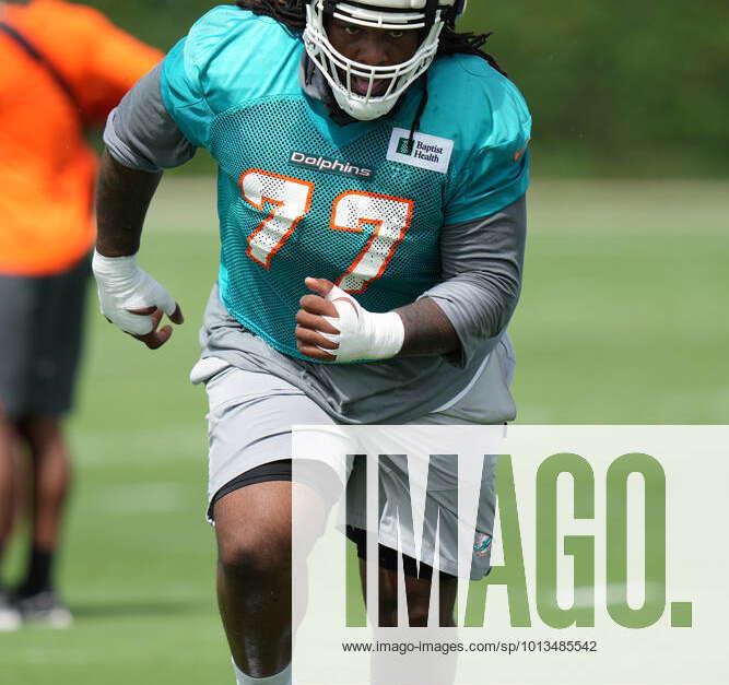 Miami Dolphins defensive tackle John Jenkins (77) walks off the