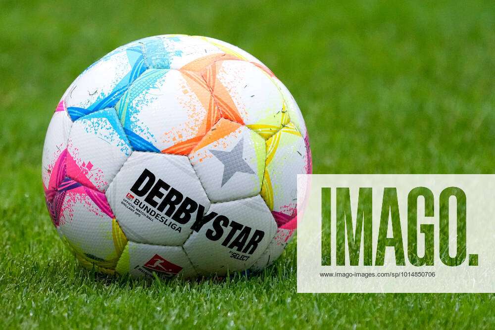 A ball of the brand Derbystar Bundesliga Brillant Aps by Select lies on the  lawn, official