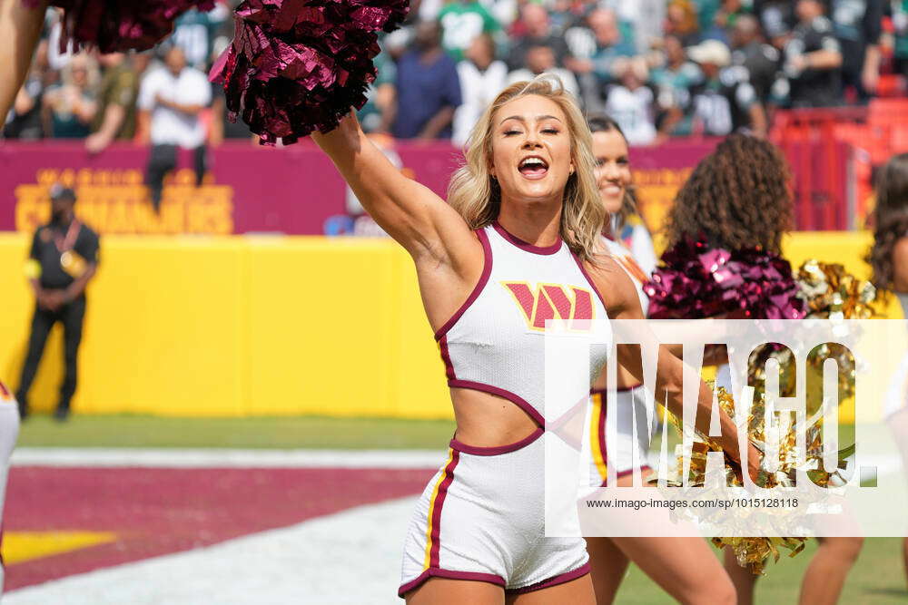 A member of the Washington Commanders cheerleaders performing on