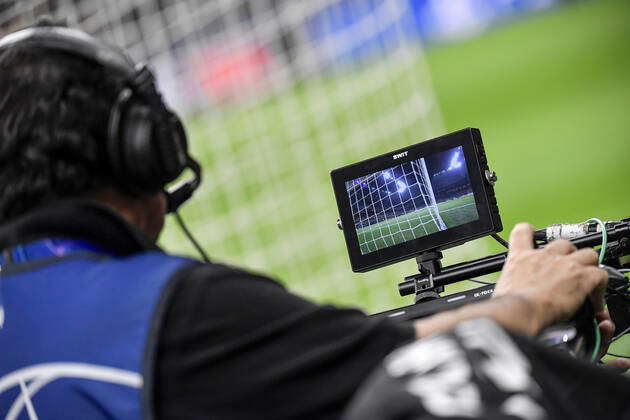 Football Gaoal Monitor A cameraman watches in the monitor as he shoots with the camera ...