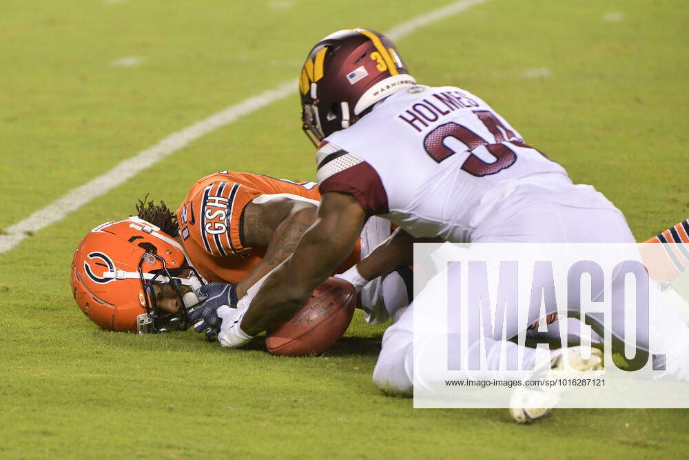 Washington Commanders cornerback Christian Holmes (34) recovers a fumble by  Chicago Bears wide recei