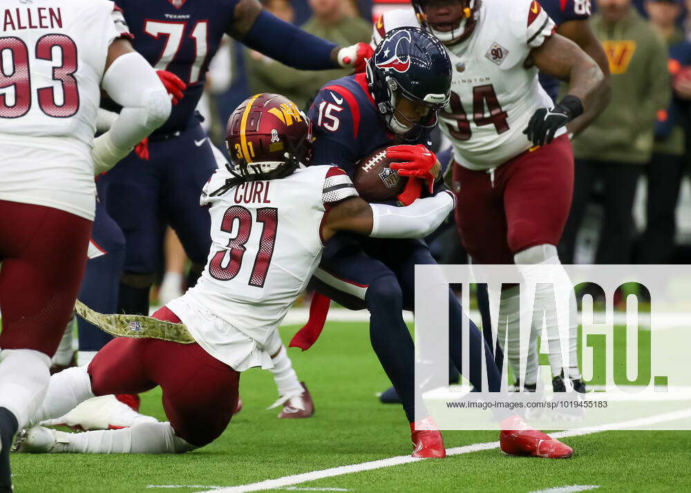 HOUSTON, TX - NOVEMBER 20: Washington Commanders safety Kamren Curl (31)  tackles Houston Texans wide