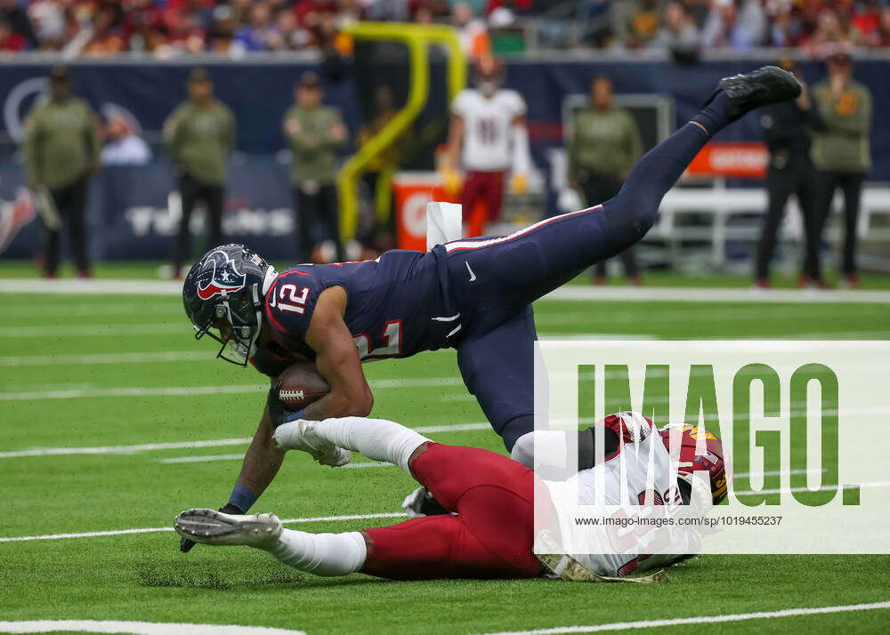 HOUSTON, TX - NOVEMBER 20: Houston Texans wide receiver Nico Collins (12)  holds on to the ball