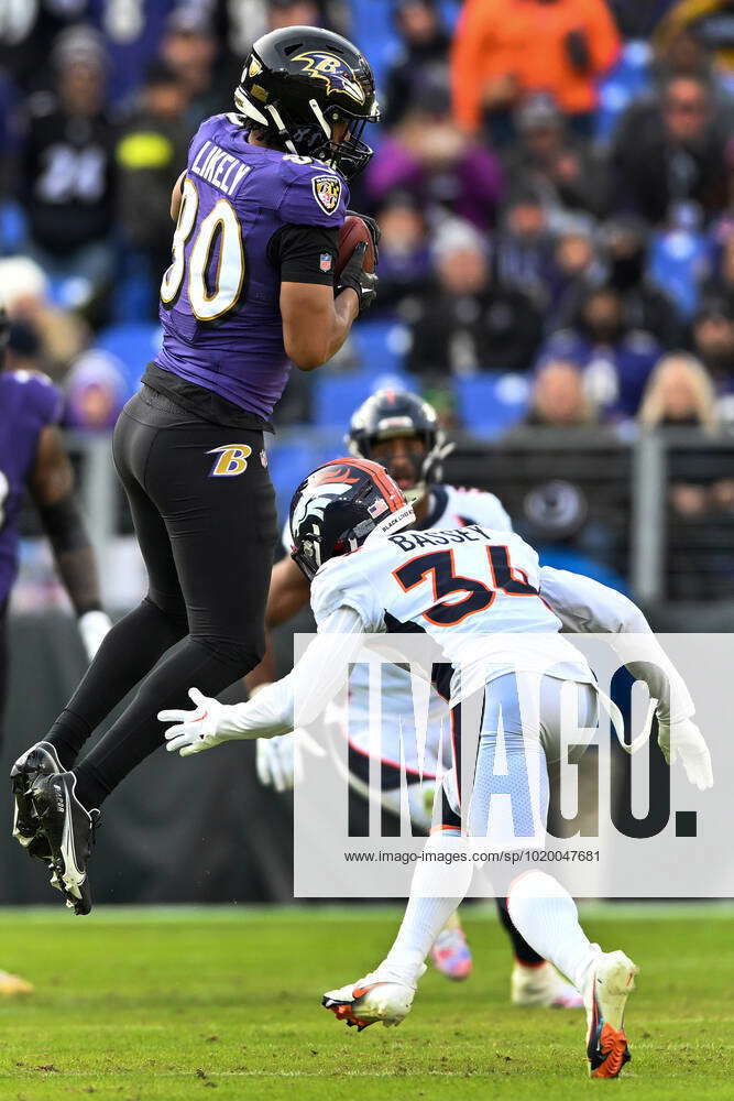 Baltimore Ravens tight end Isaiah Likely (80) makes a pass reception over  Denver Broncos cornerback